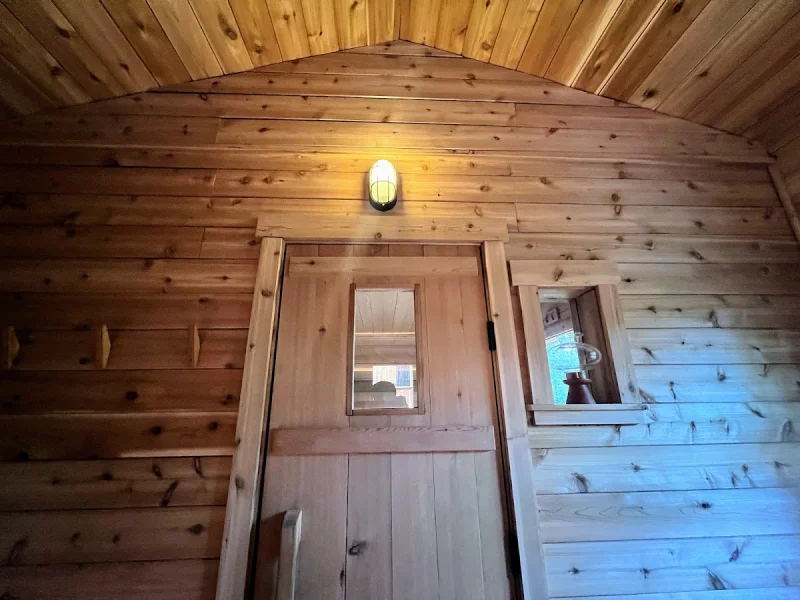 Rustic cedar entryway with arched wood ceiling and warm lighting